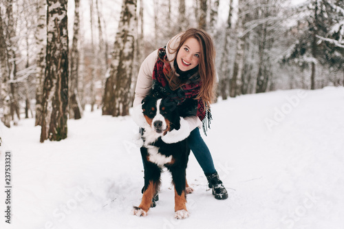 girl with dog in winter forest