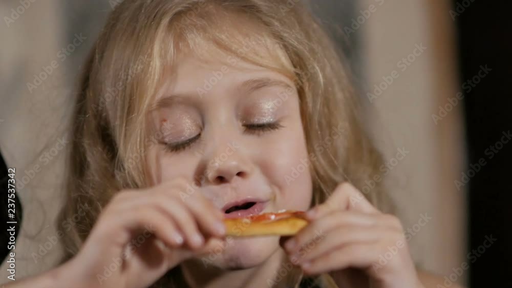 Little girl eating pizza in the restaurant Little girl eating pizza in the restaurant