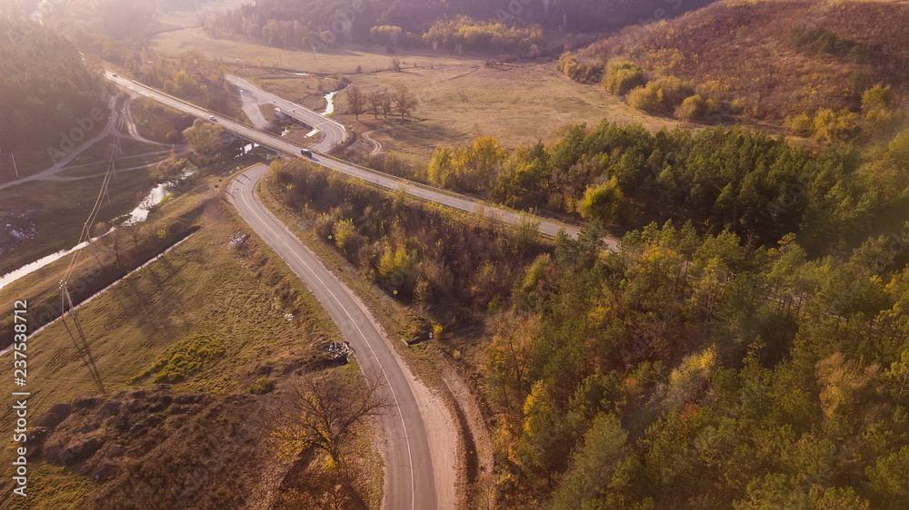 Aerial view of the road through fall forest