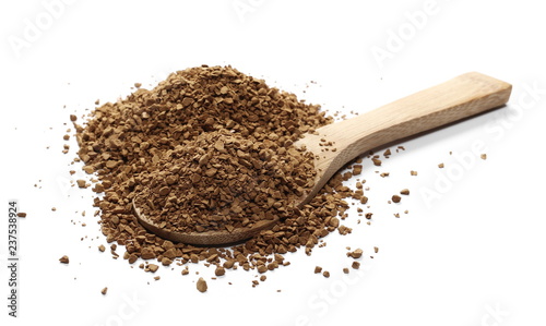 Instant coffee granules with wooden spoon isolated on white background and texture