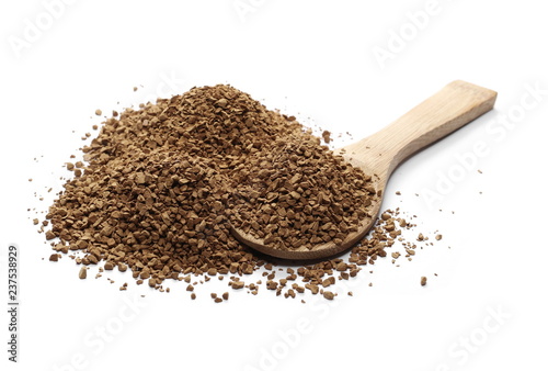 Instant coffee granules with wooden spoon isolated on white background and texture