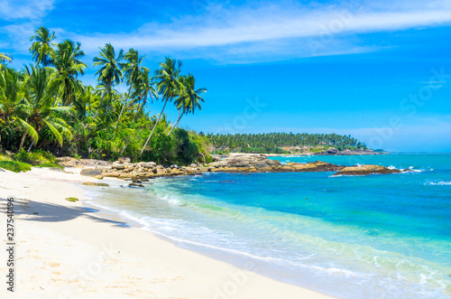 Tropical beach on a Sri Lanka s coast  coconut palms  white sand and the azure ocean. Beautiful tropical landscape