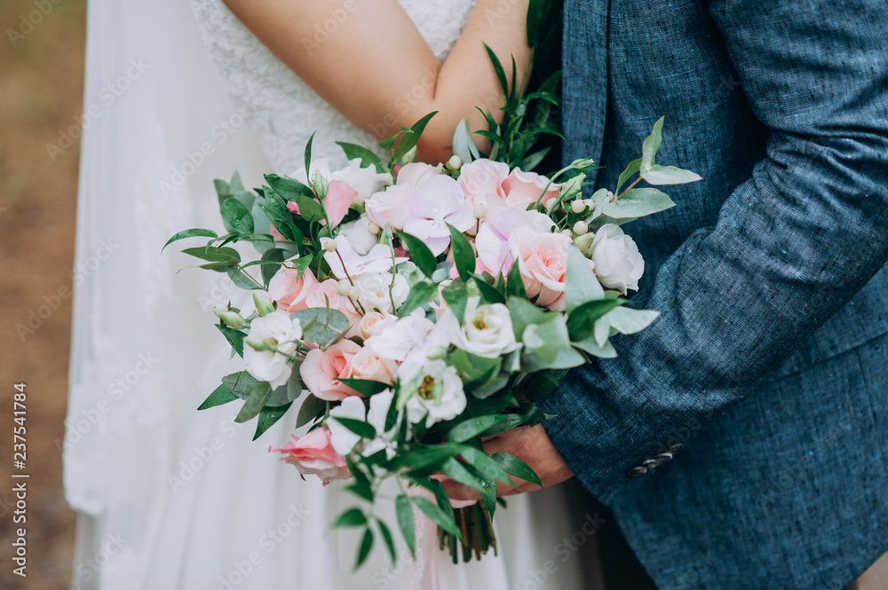 bride holding bouquet of flowers in rustic style, wedding bouquet Groom hugs bride bride holding bouquet of flowers in rustic style, wedding bouquet Groom hugs bride