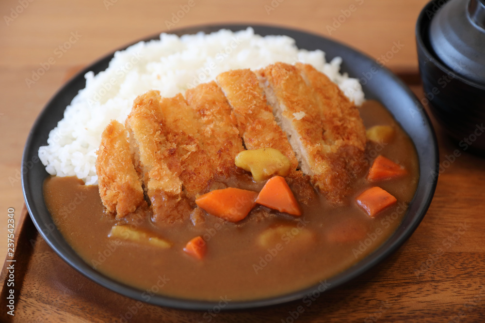 Curry rice with fried pork tonkatsu Japanese food on wooden table Curry rice with fried pork tonkatsu Japanese food on wooden table