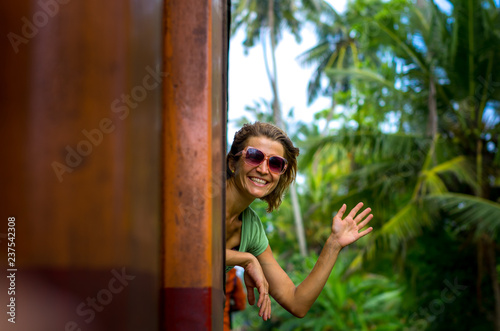 Young woman enjoying traveling by train through Sri Lanka  © Val Shevchenko