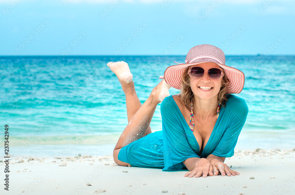 woman in fashion beachwear and hat on tropical beach on summer vacation travel. woman in fashion beachwear and hat on tropical beach on summer vacation travel.