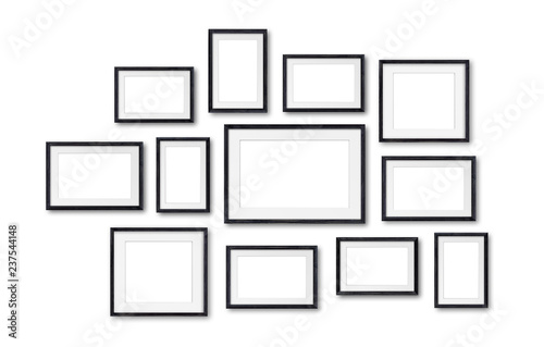 Photo frames collage , twelve black wooden frameworks isolated on white  wall