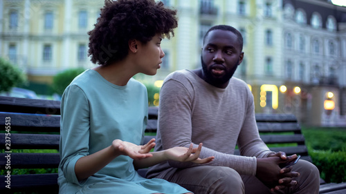 Obraz na płótnie Man and woman arguing outdoor, spouse disrespect, misunderstanding in couple