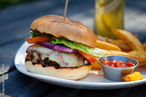 Beef burger with melted cheese and chips