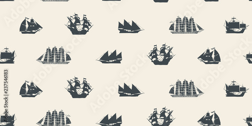 Vector seamless pattern on the theme of sea travel with various sailing ships. Sea objects on a beige background in retro style