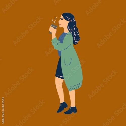 Young woman dressed in casual clothes walking and drinking coffee from paper cup
