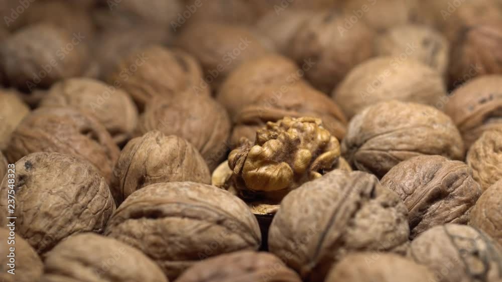 Walnuts in nutshell. Rotation. Closeup. Selective focus. Healthy food concept. Walnuts in nutshell. Rotation. Closeup. Selective focus. Healthy food concept.