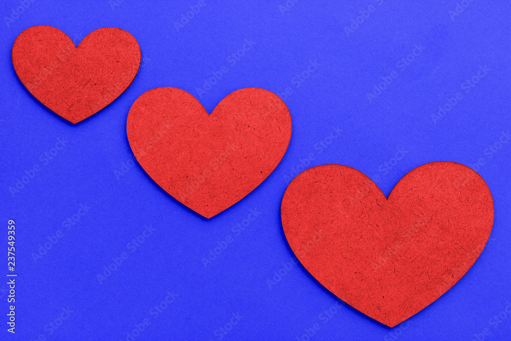 Valentine's Day Hearts of different sizes of red color on a Proton Purple trend 2019 background. Concept of love for Valentine's Day.