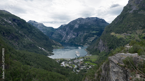 Vantage, spectacular views of Geiranger village, one of the most picturesque places at the head of Geirangerfjord, towards the surrounding mountains and cliffs, the village and the fjord, in Norway