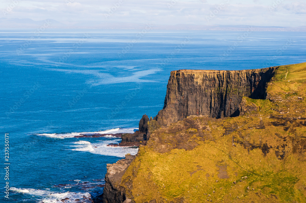 Amazing rugged cliffs facing a vast ocean seascape. Cliffs of Moher, Ireland’s most spectacular natural wonder at the heart of the Wild Atlantic Way, County Clare.