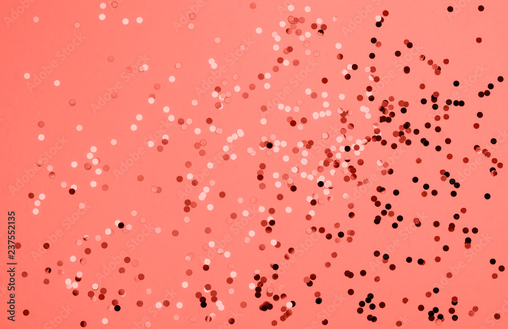 Beautiful festive coral background with confetti. Holiday decoration concept. Place for text. Color of the year 2019. Living coral.