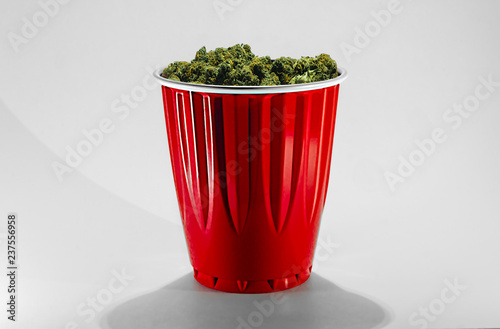 Obraz na płótnie A red plastic party cup filled with Cheese OG marijuana buds isolated with white. w salonie