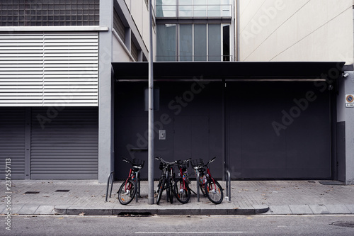 industrial district with grey warehouse, empty wall space for design layout and bicycle parking on the street.