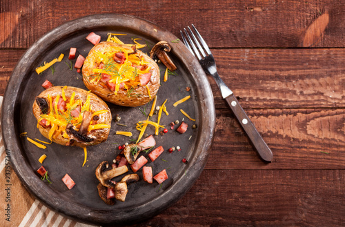 Baked stuffed potatoes with bacon, cheddar, mushrooms and dill