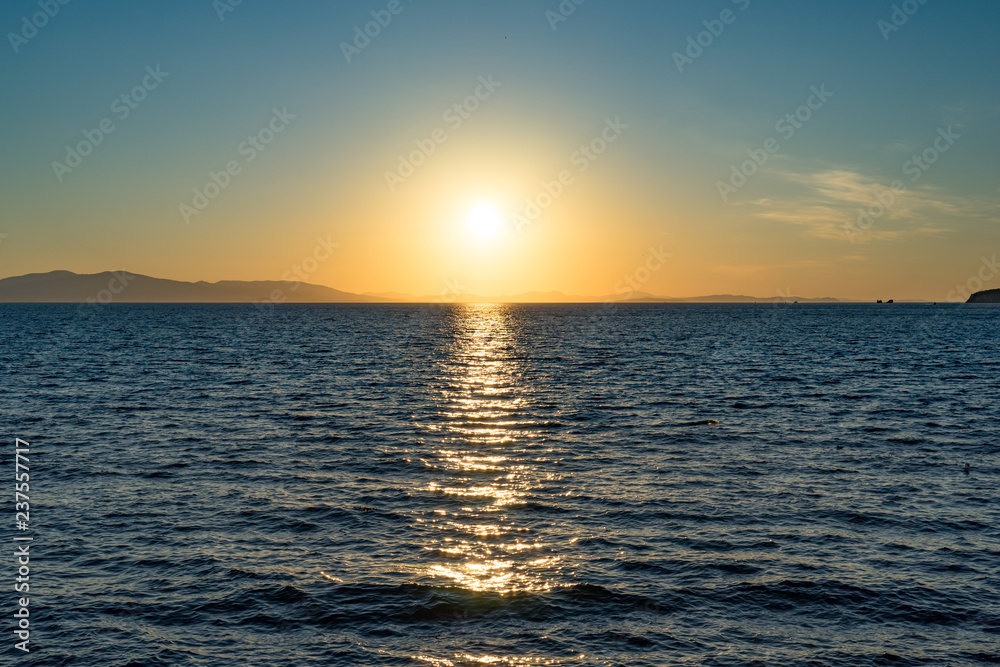 Seascape with beautiful sunset and sunset on the horizon.