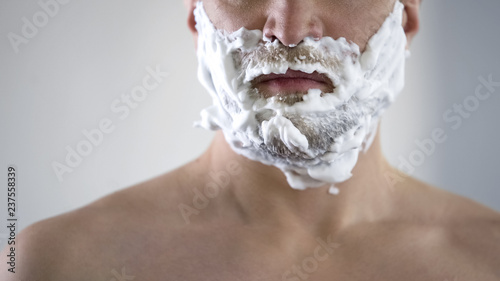 Middle-aged male disappointed and angry because of quality of new shaving foam