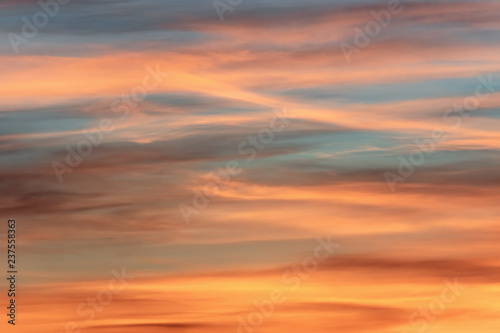 Colorful long clouds in sunset time. Like brush strokes. © Opalev