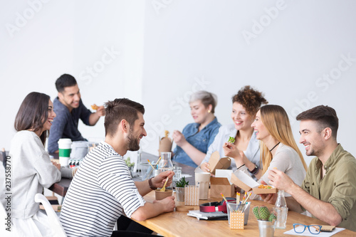 Friends and coworkers during lunch brake at modern marketing firm