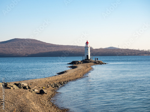 Tokarevsky lighthouse and people in the background of the Russian island of the Far Eastern city of Vladivostok. December, 2018 © ikmerc