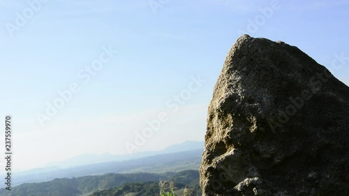 Rock and landscape .Village in background.