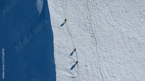Group of mountaineers climbing up on the mountain at winter