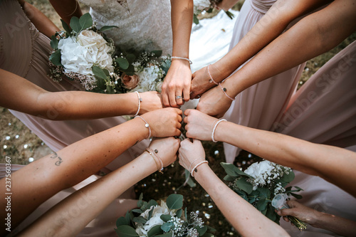 bridesmaids on a wedding putting hands together