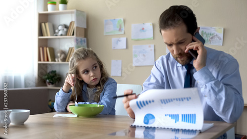 Φωτογραφία Cute girl need parental attention, father ignoring daughter talking on phone