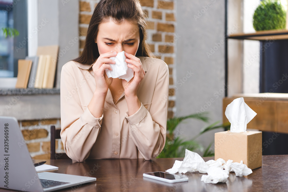 young businesswoman suffering from allergy at workplace young businesswoman suffering from allergy at workplace