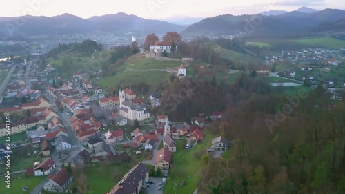 Aerial: Flying towards city Sevnica beside river Sava in Slovenia. Beautiful small city with castle is the birth place of first lady Melania Trump. photo