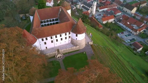 Aerial: flying around castle of city Sevnica beside river Sava in Slovenia. Beautiful small city with castle is the birth place of first lady Melania Trump. photo