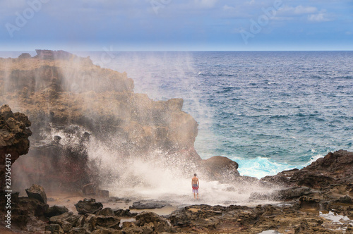 Tourists looking at a blow hole on Maui, Hawaii, USA