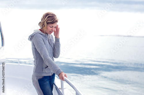 Cruise sea motion sickness tourist woman seasick on boat vacation with headache or nausea. Fear of travel or illness virus on cruising holiday. photo