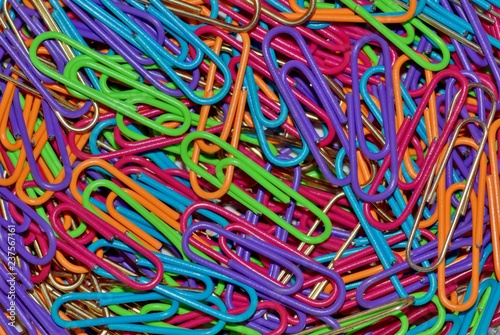 Macro photo of colored paper clips scattered randomly  filling the entire frame.