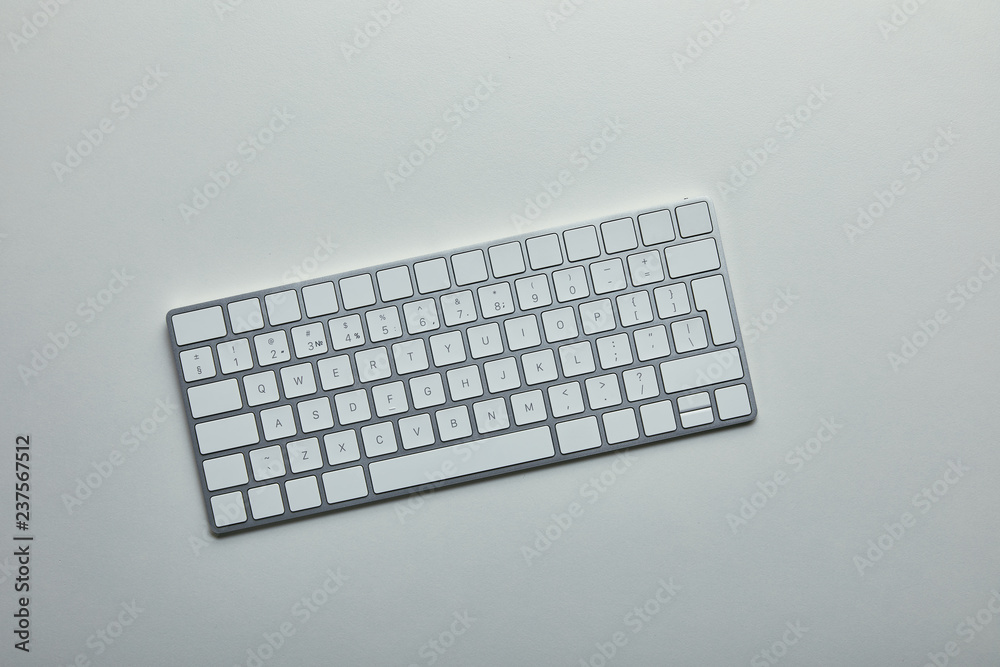 Top view of white computer keyboard on grey background Top view of white computer keyboard on grey background