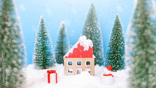 Landscape forest with christmas trees and house on the snow in winter. Concept of christmas holiday celebration and new year © sichon