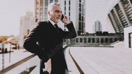 Businessman is Talking on Mobile Phone photo