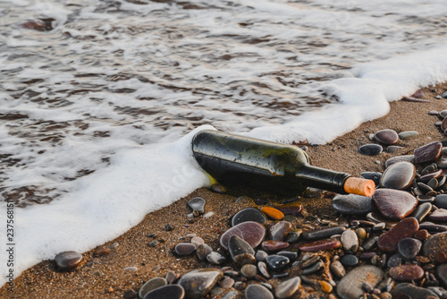 Wine bottle on a sandy beach