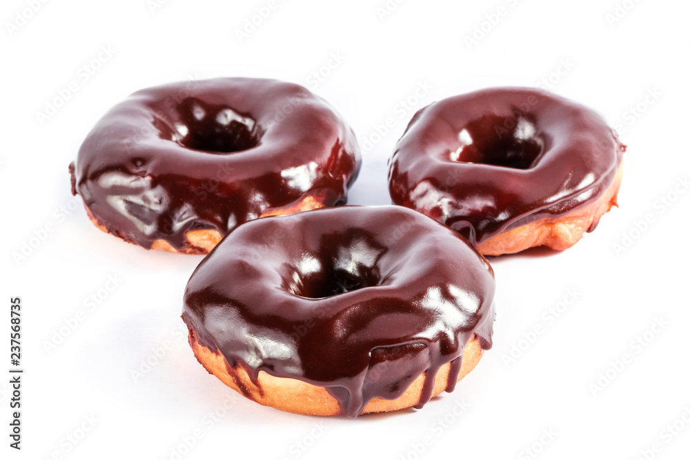 Donuts in chocolate glaze isolated on white background Donuts in chocolate glaze isolated on white background