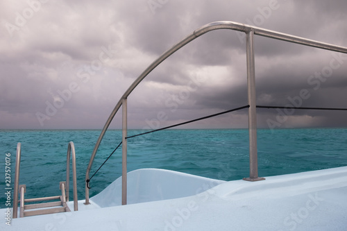 Close up of a part of a Catamaran sailing on the Caribbean Sea on a overcast day by Grand   Cayman Islands