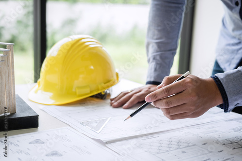 Construction engineering or architect hands working on blueprint inspection in workplace, while checking information drawing and sketching for architecture project working