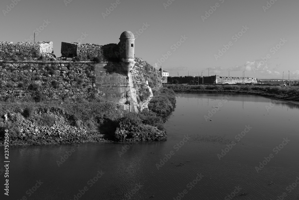 old fort surrounded by water in Peniche, Portugal in black and white