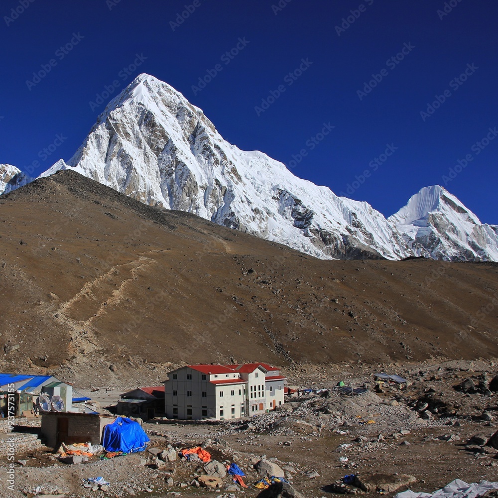 Hotels in Gorak Shep, last place before the Everest Base Camp. Snow capped Mount Pumori 7161 m and Kala Patthar.