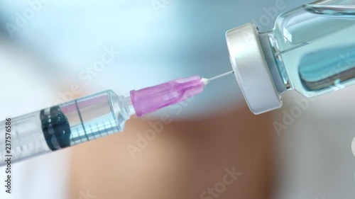 doctor uses a syringe to dispense medication from the bottle. at the hospital. Health and medical concepts photo