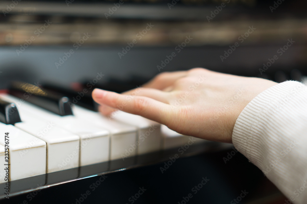 Fototapeta premium Child learning to play the piano.