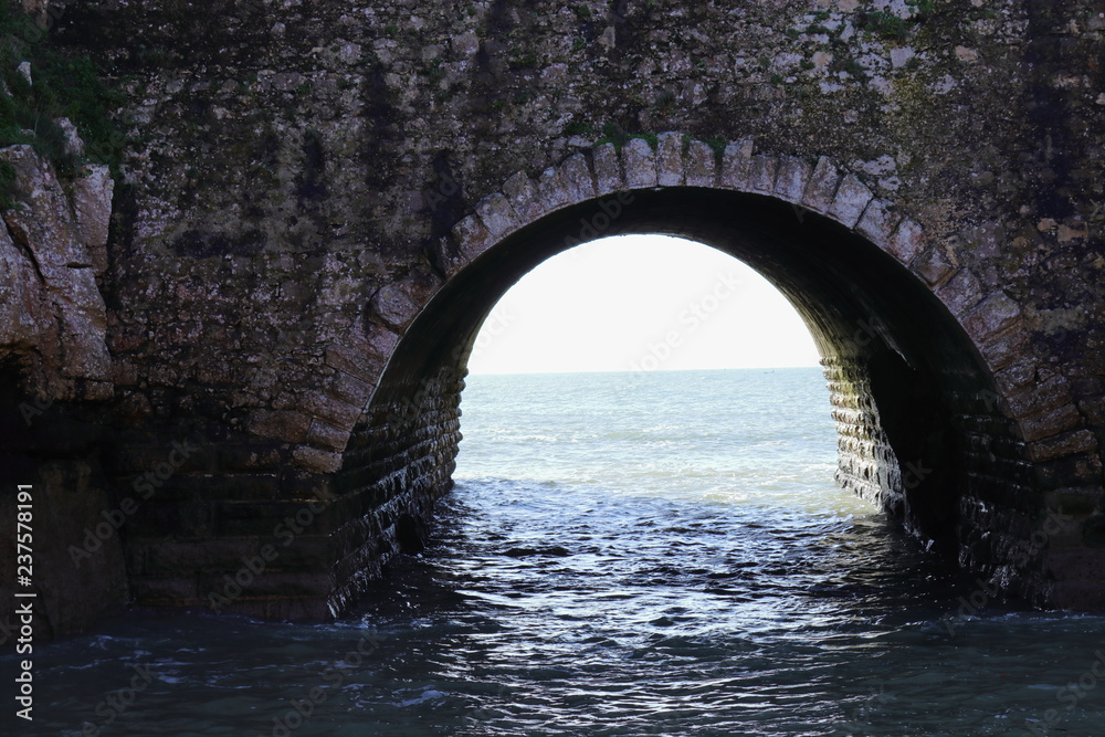 stone arch and water entrance in Peniche Fortress, former prison